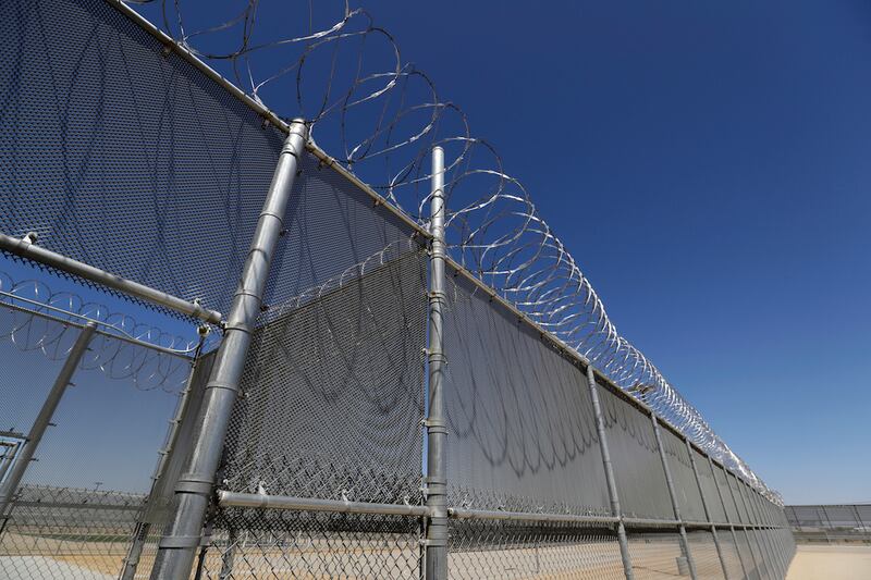 FILE - Shown is the Adelanto U.S. Immigration and Enforcement Processing Center operated by GEO Group, Inc. (GEO) a Florida-based company specializing in privatized corrections in Adelanto, Calif., on Aug. 28, 2019. California's attorney general on Wednesday, Nov. 17, 2021, asked the full 9th U.S. Circuit Court of Appeals to reconsider a ruling that rejected the state's first-in-the-nation ban on for-profit private prisons and immigration detention facilities. (AP Photo/Chris Carlson, File)