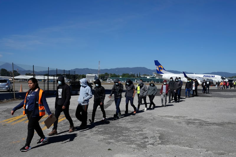 Unaccompanied Guatemalan children who were deported from Mexico deplane at La Aurora International Airport, in Guatemala City, Tuesday, Feb. 7, 2023. The children were stopped in the border between Mexico and United States. (AP Photo/Moises Castillo)