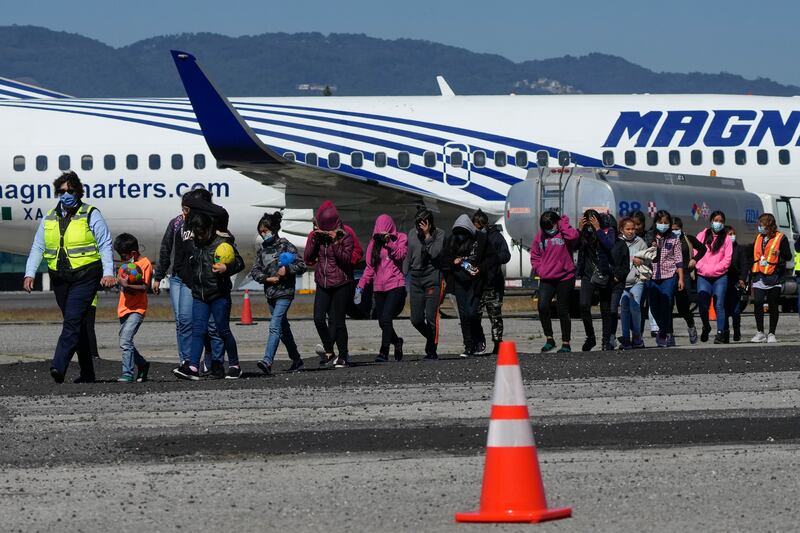 Unaccompanied Guatemalan children who were deported from Mexico deplane at La Aurora International Airport, in Guatemala City, Tuesday, Feb. 7, 2023. The children were stopped in the border between Mexico and United States. (AP Photo/Moises Castillo)